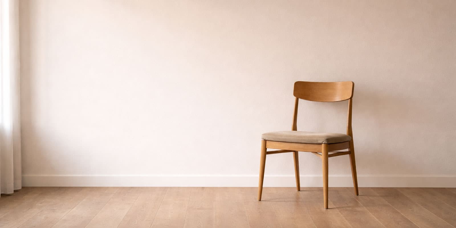 Living with Reiki - Substack image of a chair against a blank wall