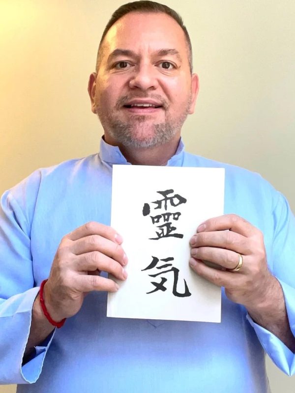 Photo of Brian Brunius with the Reiki Grey Book