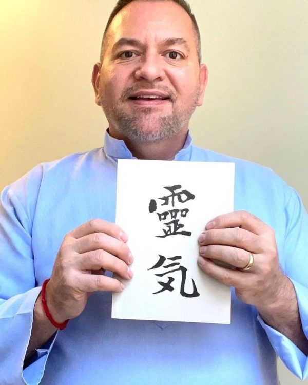 Photo of Brian Brunius with the Reiki Grey Book